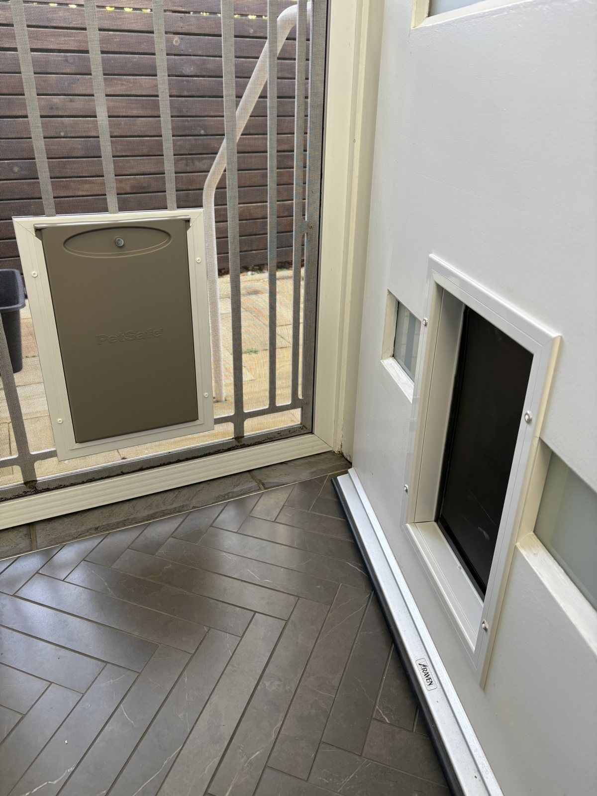 PetSafe pet doors installed in a security screen and timber door