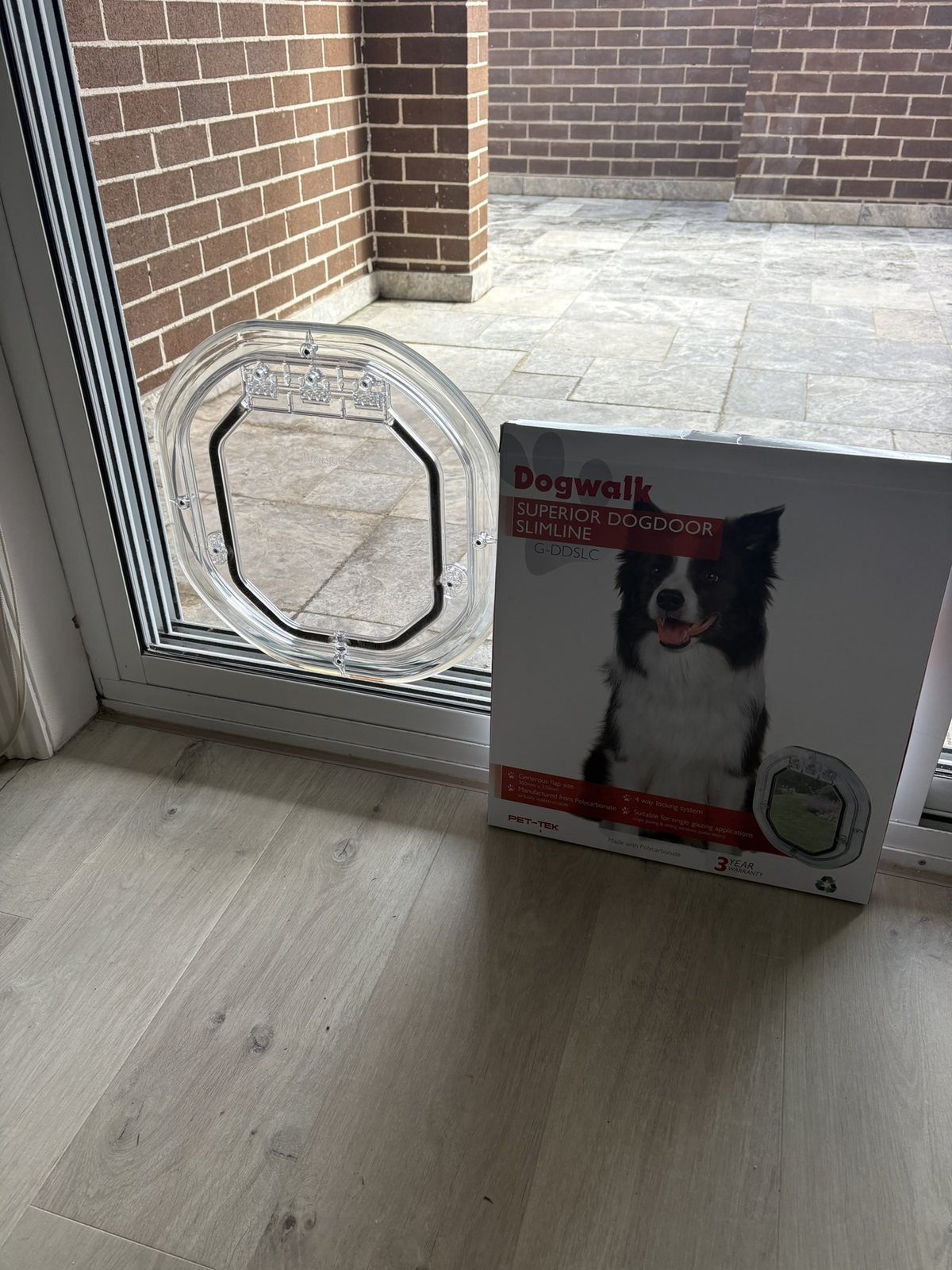 Dogwalk dog door installed in glass